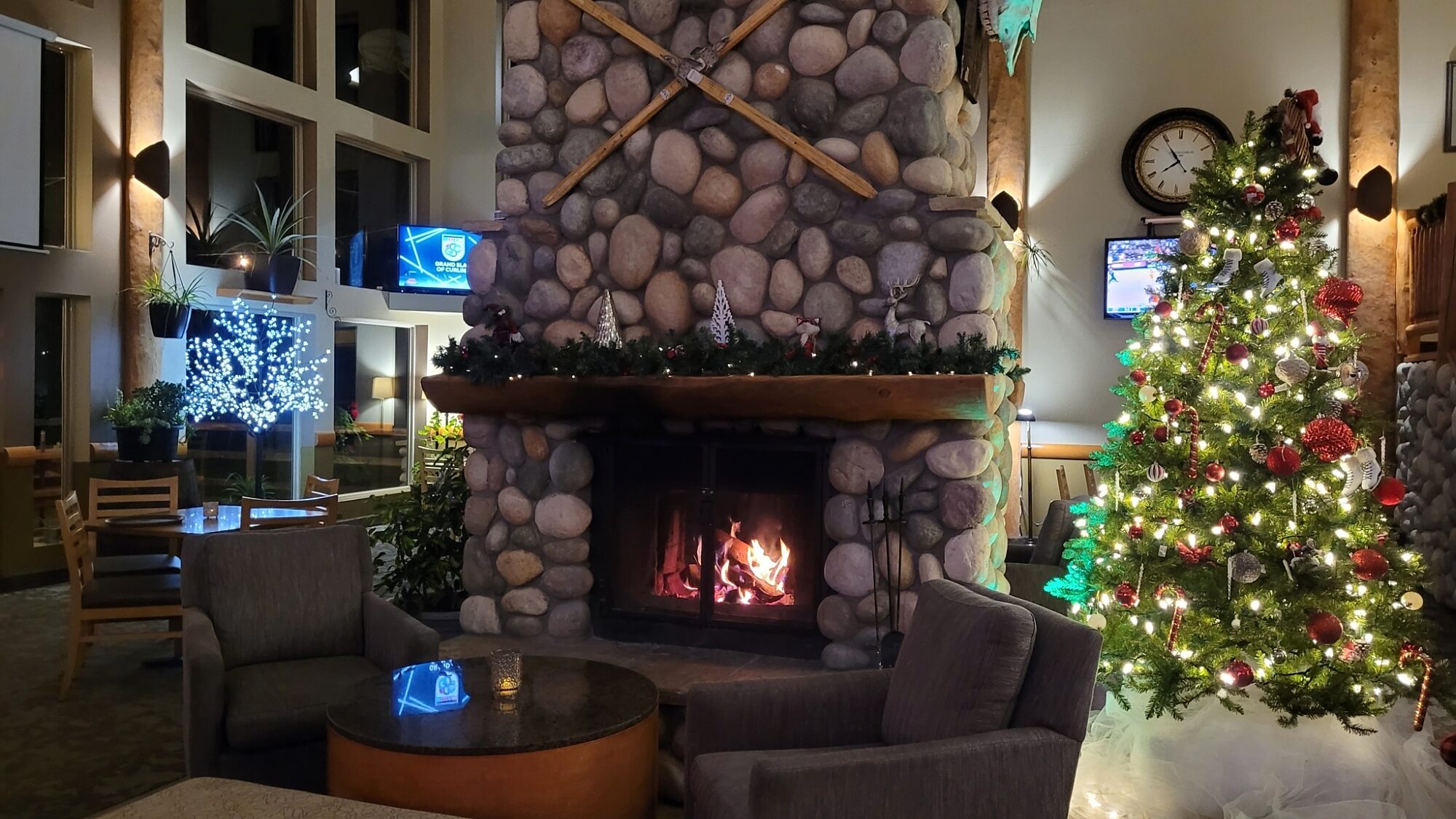 Lobby lounge featuring a fireplace and decorated Christmas tree at Best Western Plus Valemount