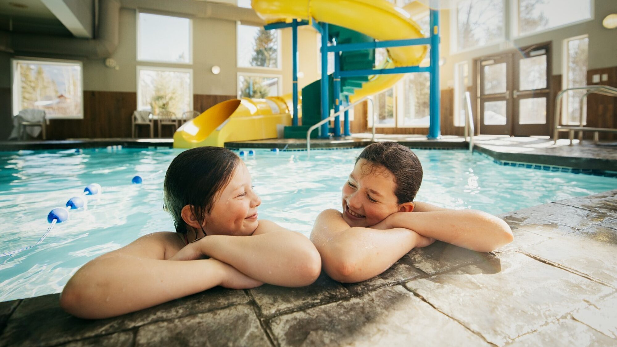 Guests leaning on the pool edge inside the indoor pool at Best Western Plus Valemount