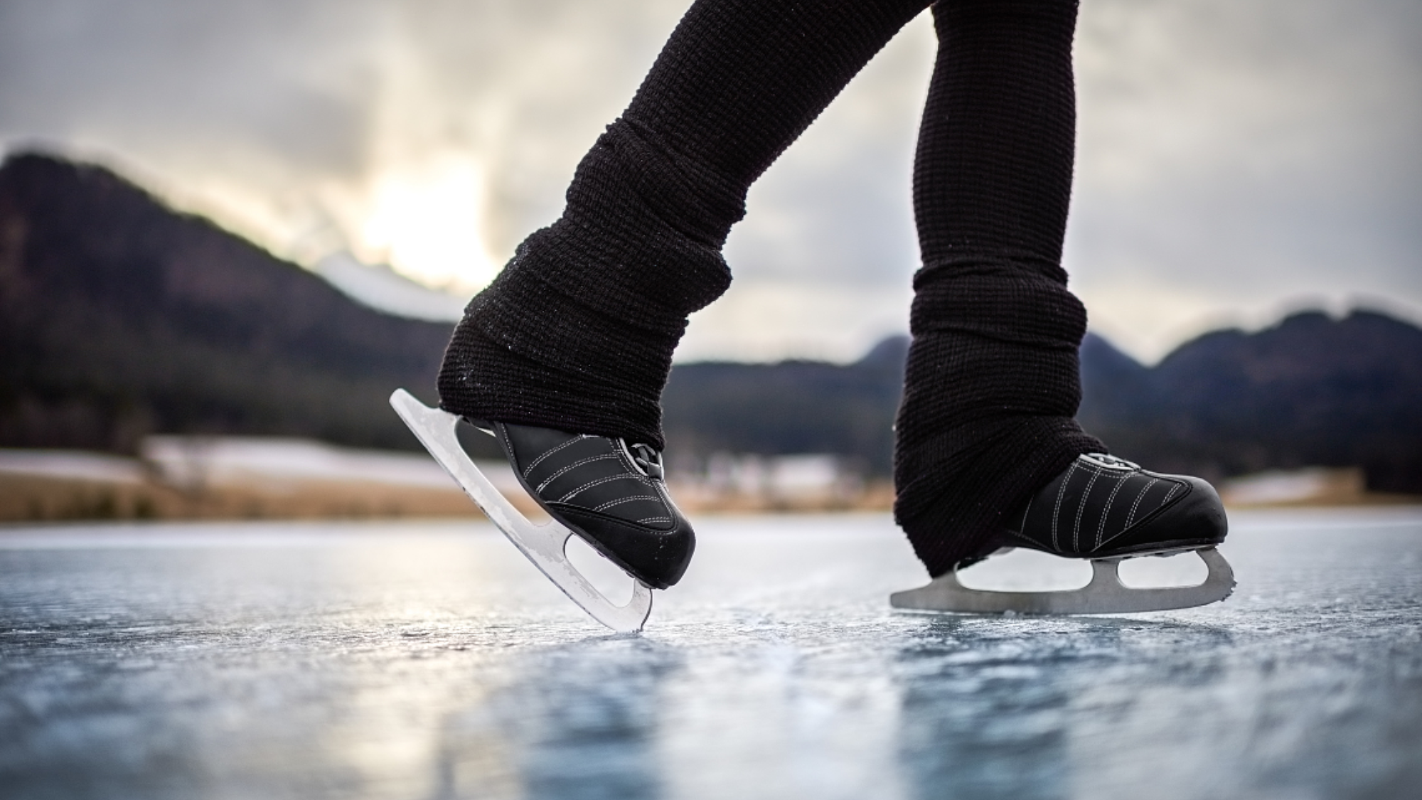 Person wearing ice skates standing on a frozen ice surface