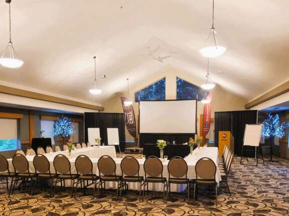 Event room with chairs arranged facing a presentation screen at Best Western Plus Valemount