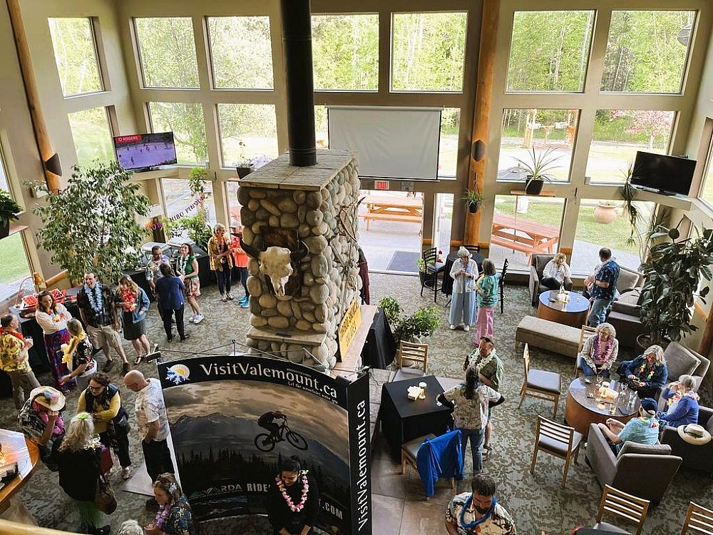 Guests gathered in the hotel lobby near a stone fireplace at Best Western Plus Valemount