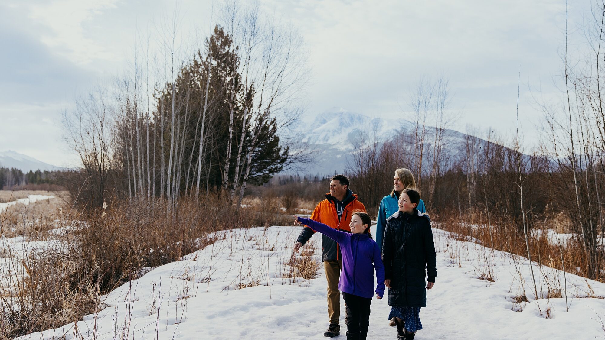 People walking on a winter trail with snow on the ground