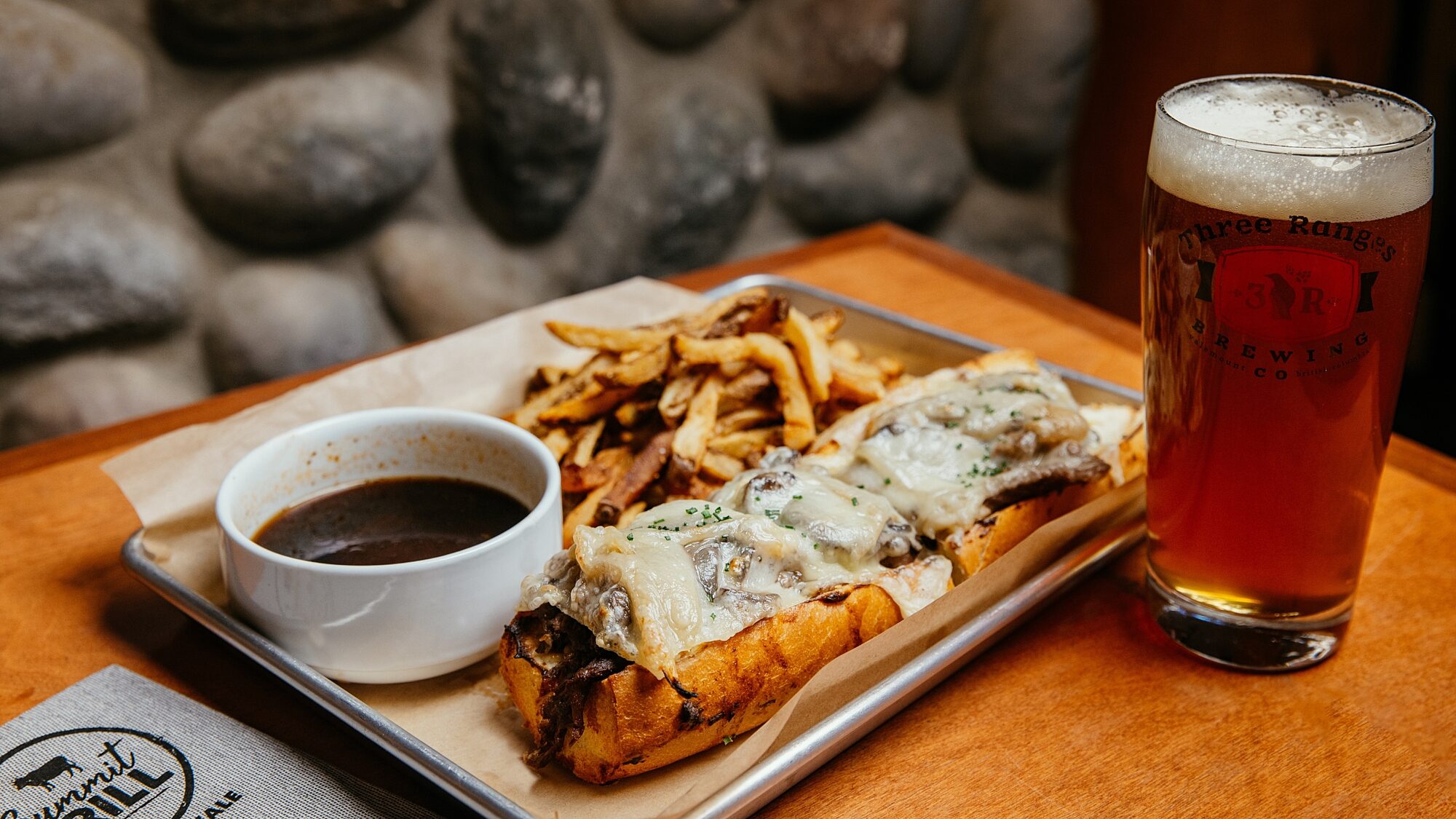 Hot meal with fries and a drink served at a dining table