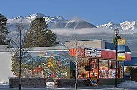 Infinity Office and Health storefront in Valemount with colorful mural and mountain backdrop