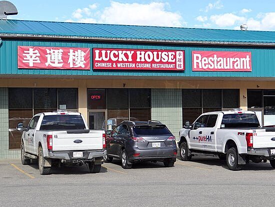 Lucky House Chinese restaurant storefront with parked vehicles in Valemount