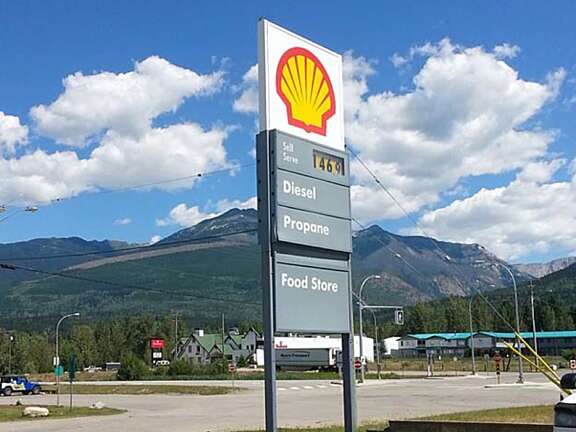 Shell Mighty Mart service station sign listing fuel and amenities along a Valemount roadway