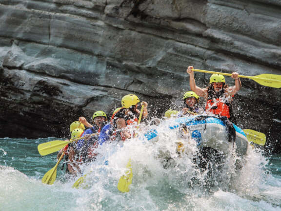 Guided whitewater rafting with Stellar Descents, navigating rapids through a canyon