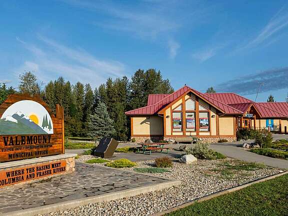Exterior of Valemount Visitor Centre with visitor information signs and parking area