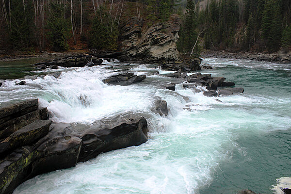 Rearguard Falls with fast-flowing water cascading over rocky river ledges in Valemount, British Columbia