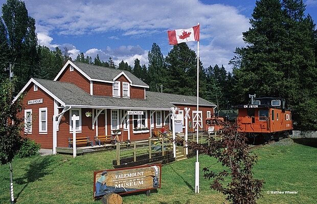 Exterior of Valemount & Area Museum building with Canadian flag and historic train car