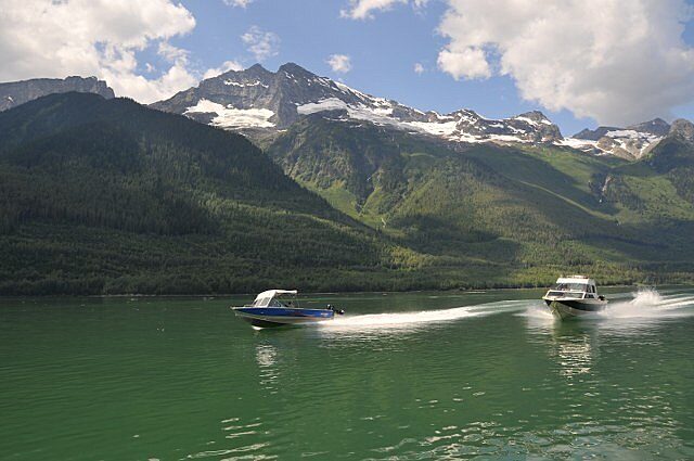 Boats traveling on Kinbasket Lake at Valemount Marina with mountain surroundings