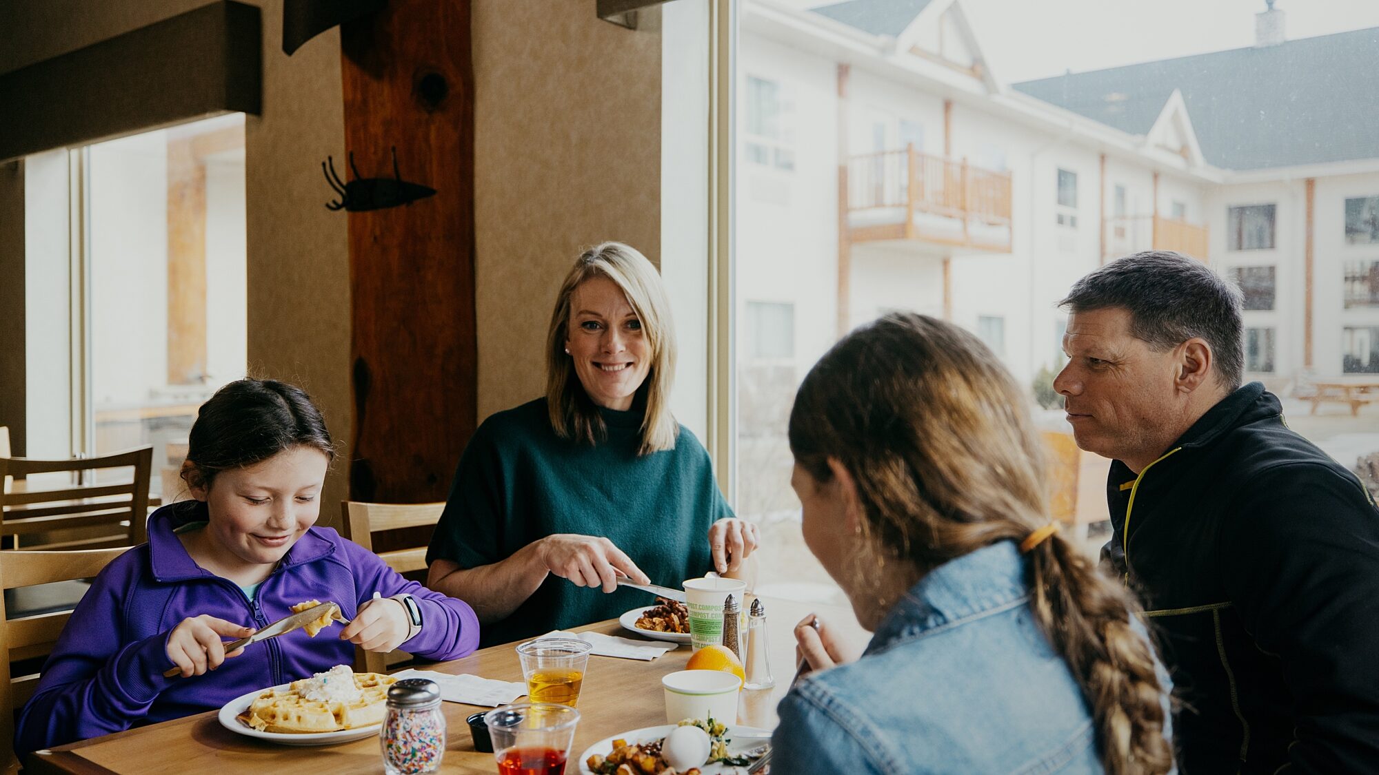 Family seated at a table enjoying a meal together indoors