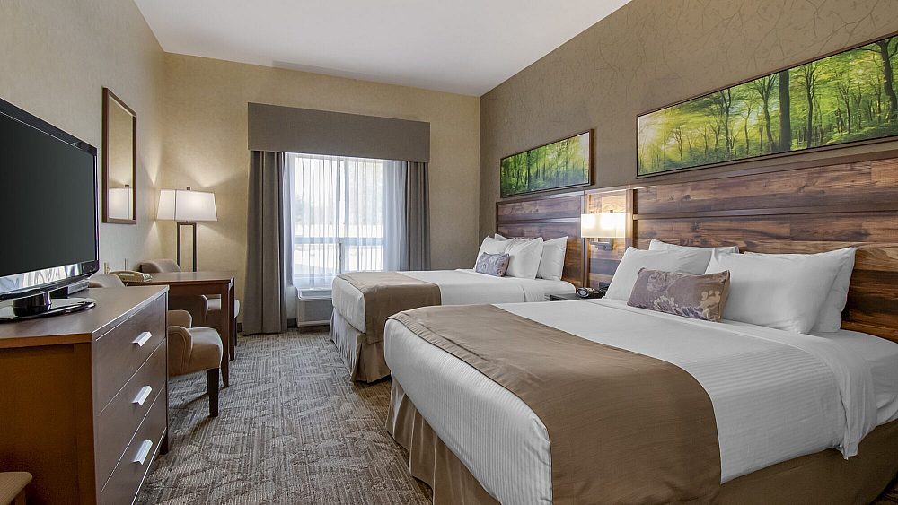 Classic room featuring two queen beds with work desk and television